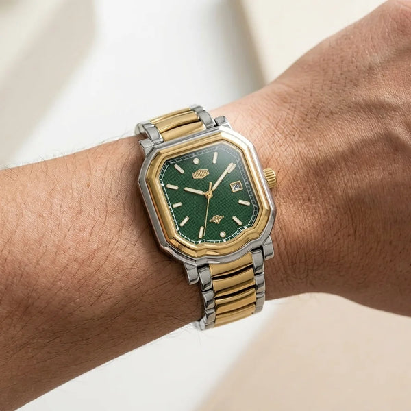 Wrist shot, modern luxury, soft daylight - Two tone stainless steel wristwatch with a green textured dial and date display.