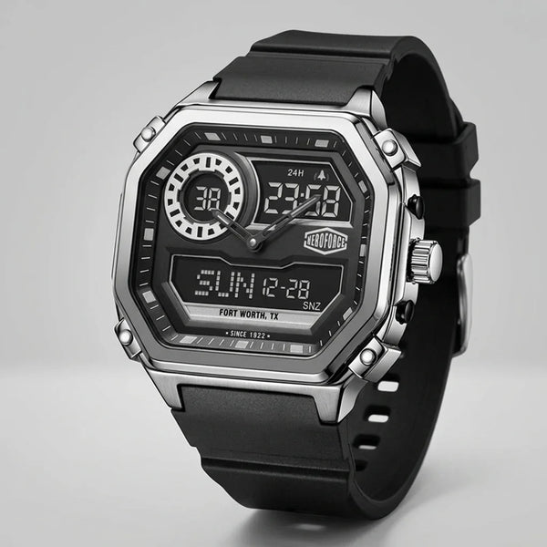 A rugged digital wrist watch with a black rubber strap, a silver-tone metal case, and a black face featuring analog hands, digital displays, and a visible TAG Heuer logo.