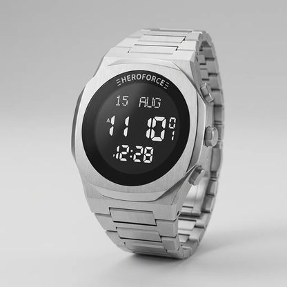 A silver stainless steel digital watch with a black face and white LED-style display, shown on a clean light gray background. The brand name 'HEROFORCE' is visible above the screen.