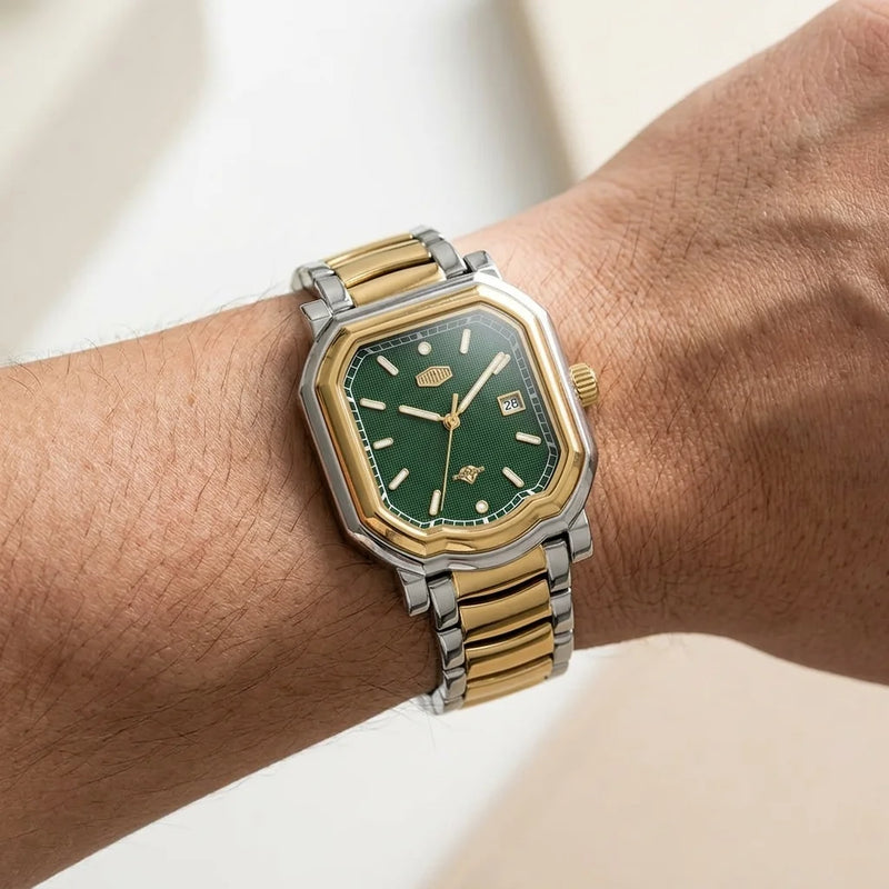 Wrist shot, modern luxury, soft daylight - Two tone stainless steel wristwatch with a green textured dial and date display.