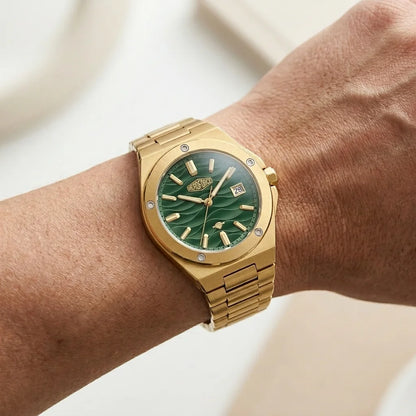 blue steel wristwatch elegant - Gold tone stainless steel wristwatch with a green wave patterned dial and date display.